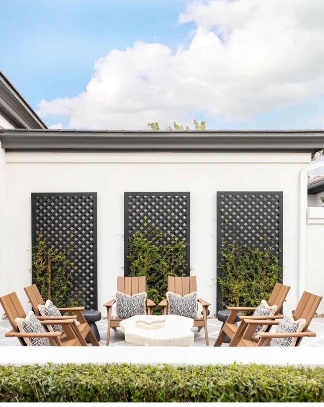 Courtyard with teak chairs and crisp patterned outdoor pillows